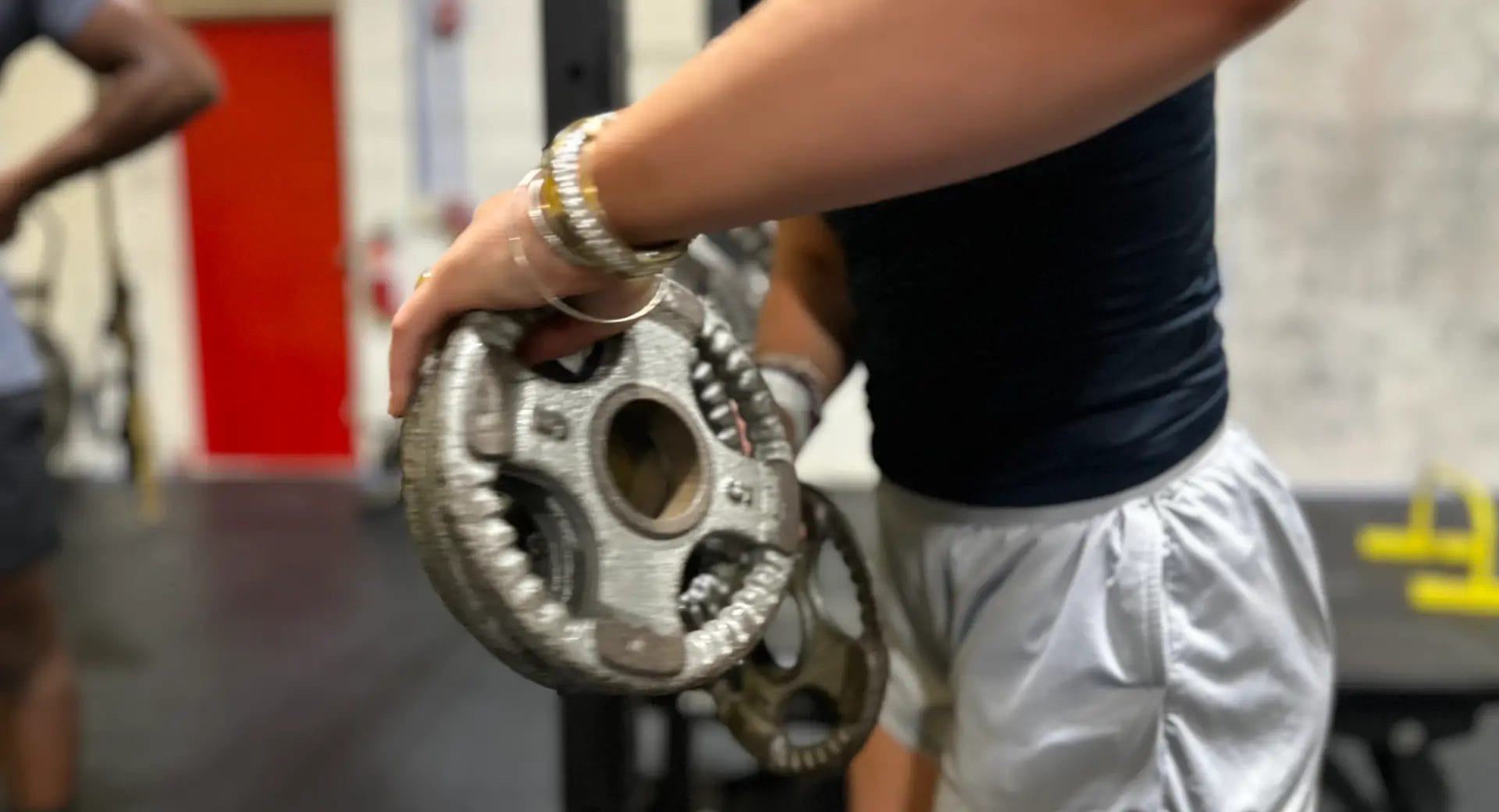 Woman holding weights in Shea Training Systems